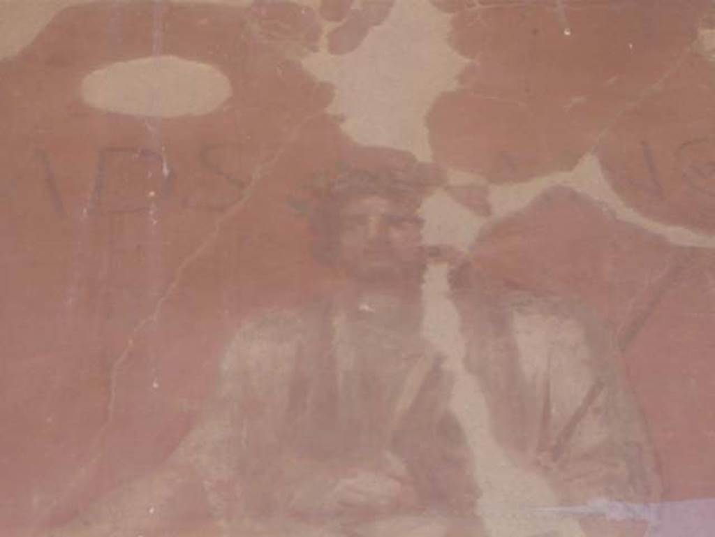 VI.14 Herculaneum, August 2013. Detail of the painted figure at the top of the painted pilaster on the left of the entrance doorway. Photo courtesy of Buzz Ferebee.
According to Cooley,
“the words ad Sancum appear painted next to an image of a bearded togate figure holding a libation dish and a staff, with his head garlanded. This figure has been interpreted as being the god Semo Sancus, associated with guaranteeing oaths.”
See Cooley, A. and M.G.L., 2014. Pompeii and Herculaneum: A Sourcebook. London: Routledge, (p.266-7, H80, (AE (1989)182c).